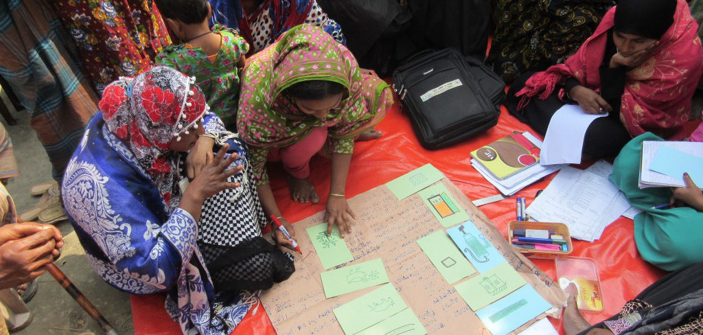 Two women in Bangladesh planning disaster response work in their community